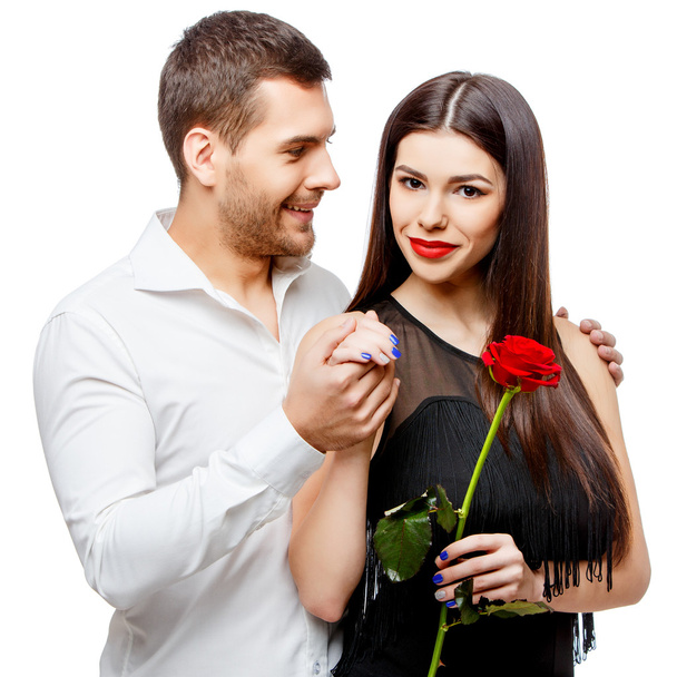 Young beautiful couple with flowers isolated on white - Foto, Imagen