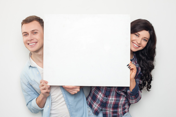 Attractive man and woman are advertising a placard - Photo, Image