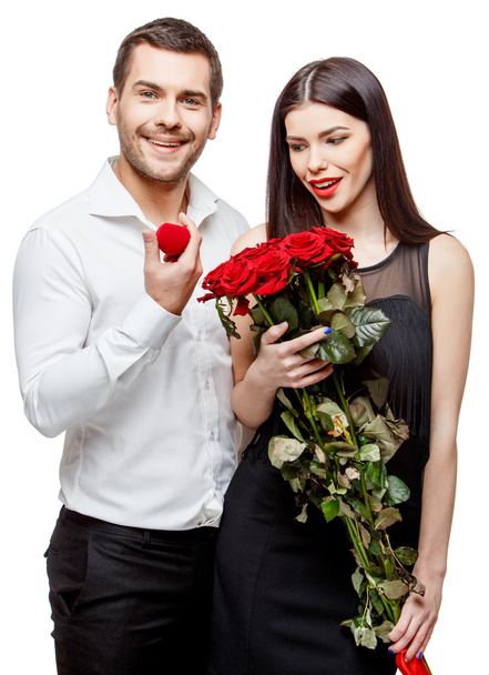 Young beautiful couple with present isolated on white - Foto, Bild