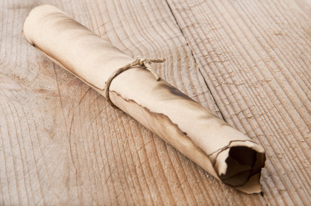 An old scroll on an old wooden background - Foto, Bild