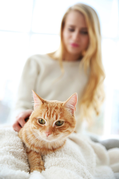 Young woman posing with red cat - Φωτογραφία, εικόνα
