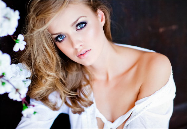Portrait closeup sensual blonde girl with blue eyes in white shirt - Фото, зображення