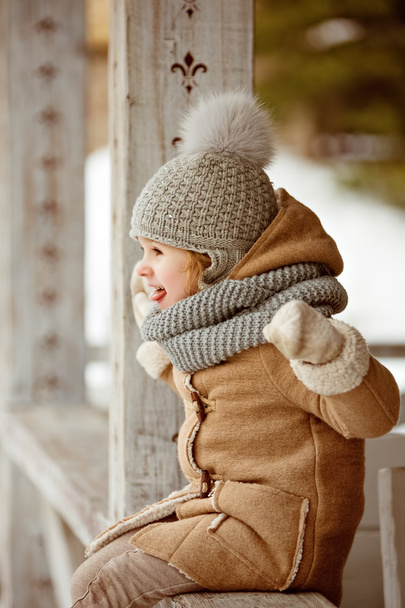Very nice beautiful girl child in a beige coat and a gray hat to - Fotografie, Obrázek