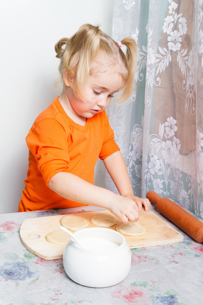 Little girl making dough in the kitchen. - Photo, Image