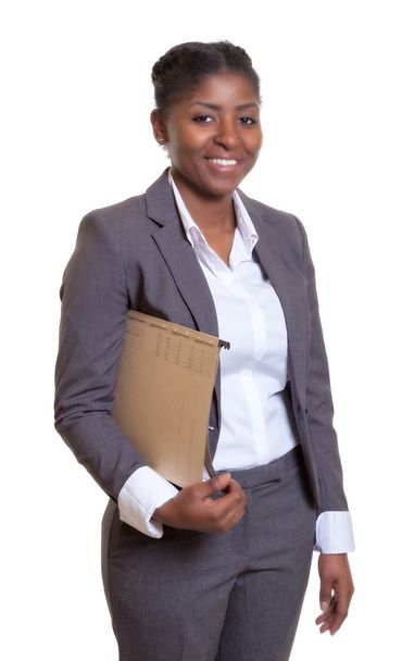 Laughing african business woman with file - Foto, afbeelding