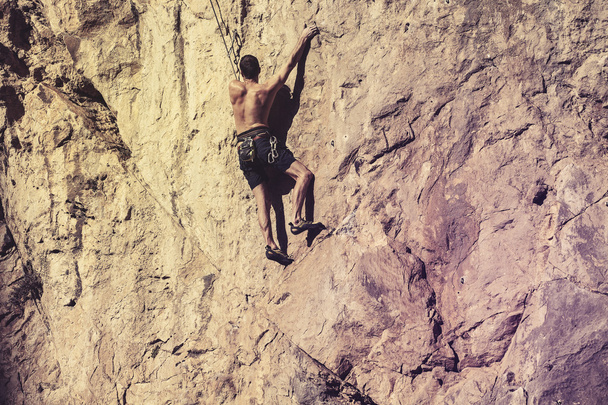 Man climbing a mountain wall. - Valokuva, kuva