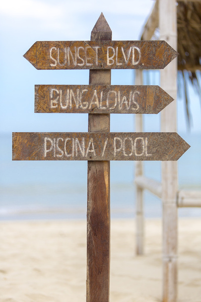 Wooden sign post to bungalows and the pool on beach, Peru - Photo, Image