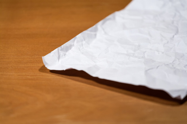 Crumpled paper on a wooden table. - Foto, imagen