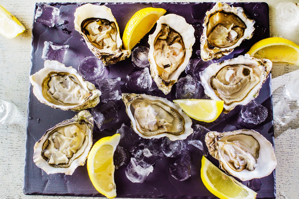 Opened Oysters on table - Photo, Image