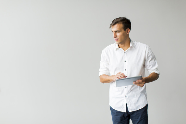 Man with tablet by the wall - Photo, image