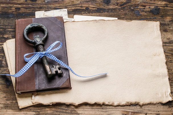 Vintage iron key, old book and secret letters - Foto, afbeelding