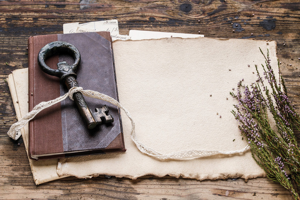 Vintage iron key, old book and secret letters - Foto, Bild