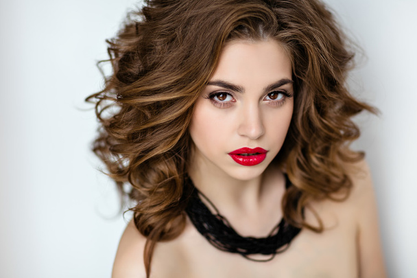 Portrait of a beautiful glamorous brunette with curly hair and b - Zdjęcie, obraz