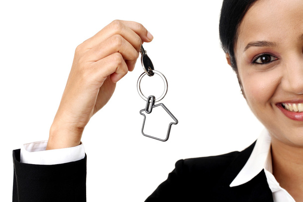 Cheerful businesswoman holding house key - Photo, Image