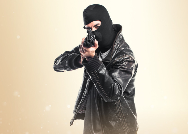 Robber holding a rifle - Foto, afbeelding