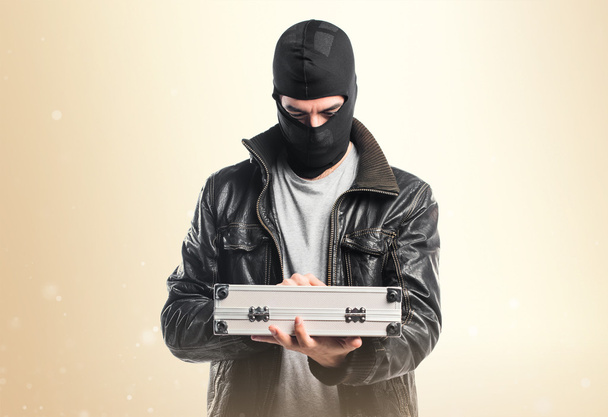 Robber holding a briefcase - Foto, afbeelding