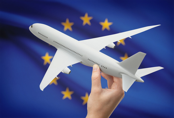 Airplane in hand with flag on background - European Union - Valokuva, kuva