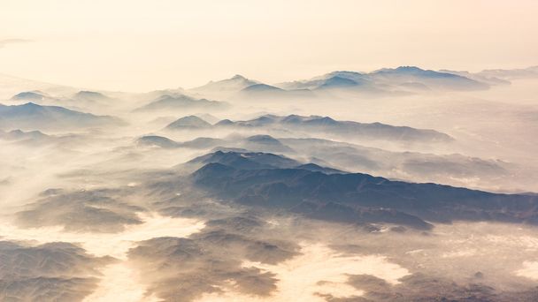 Panoramic view of mountains and clouds from airplane - Photo, image