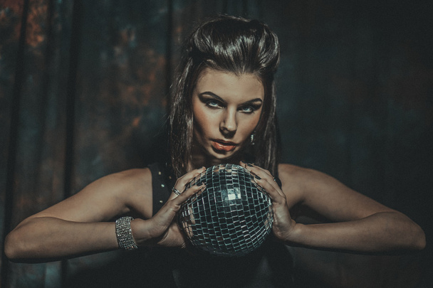 Beautiful young sensual woman holding disco ball - Φωτογραφία, εικόνα