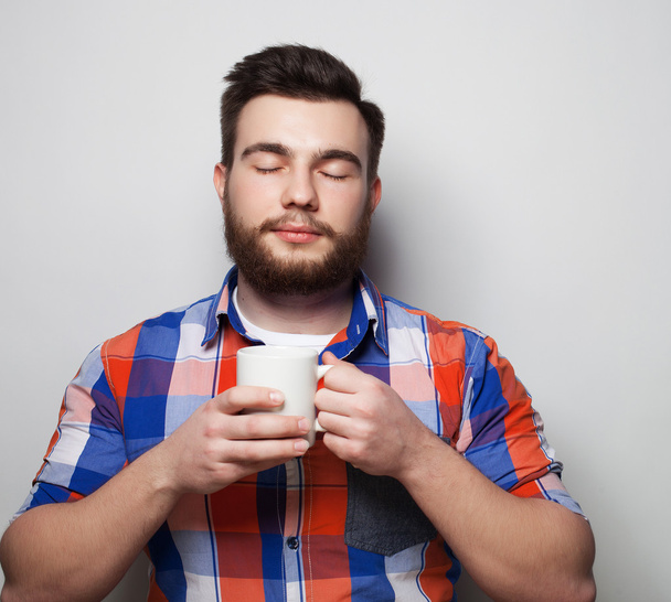 young bearded man with a cup of coffee - Photo, image