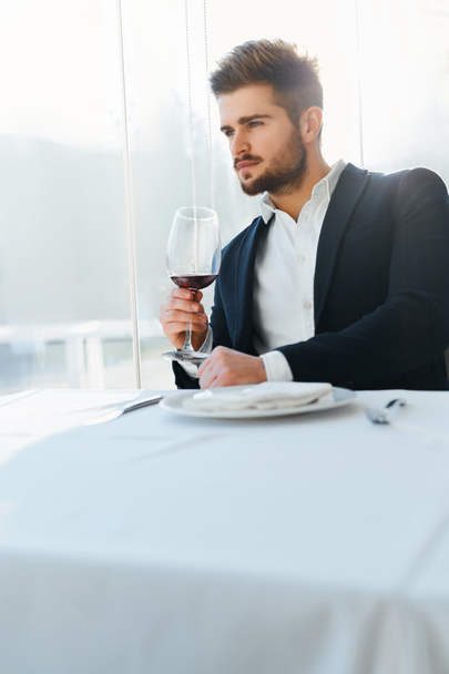 Drink. Handsome Man Drinking Wine In Restaurant. Business Man Su - Foto, afbeelding