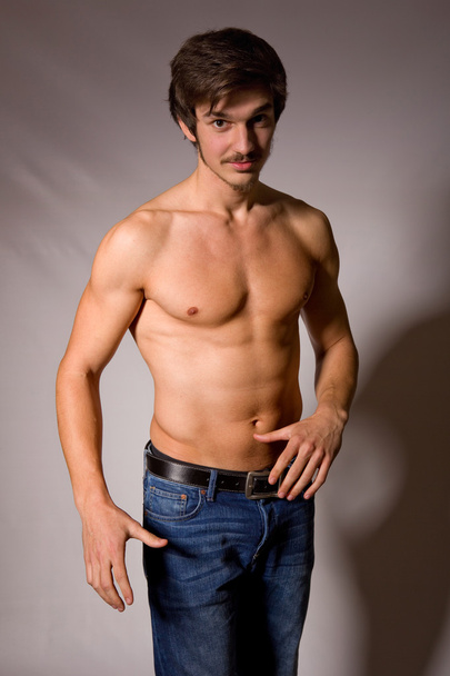 young sensual man on a black background - Fotó, kép