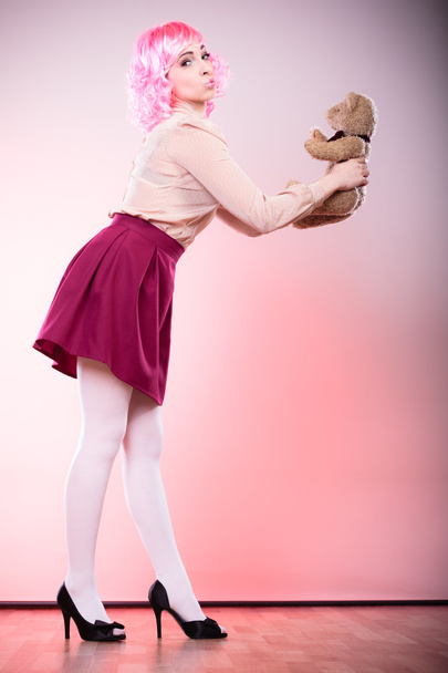 childlike woman with teddy bear - Foto, afbeelding
