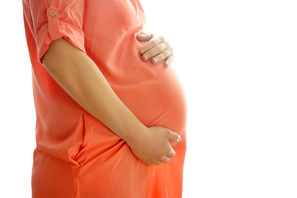 Immagine di una donna incinta che si tocca la pancia con le mani - Foto, immagini