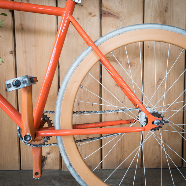 fietsen geparkeerd met houten panelen met vaste versnellingen close-up in beeld - Foto, afbeelding
