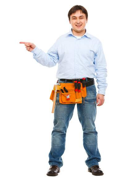 Full length portrait of construction worker pointing on side - Foto, imagen