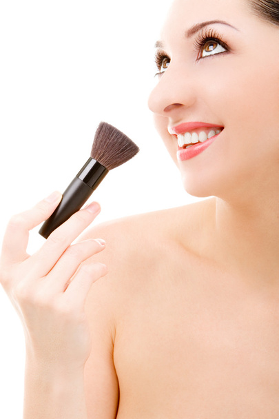 Pretty young woman with a make-up brush - Photo, Image
