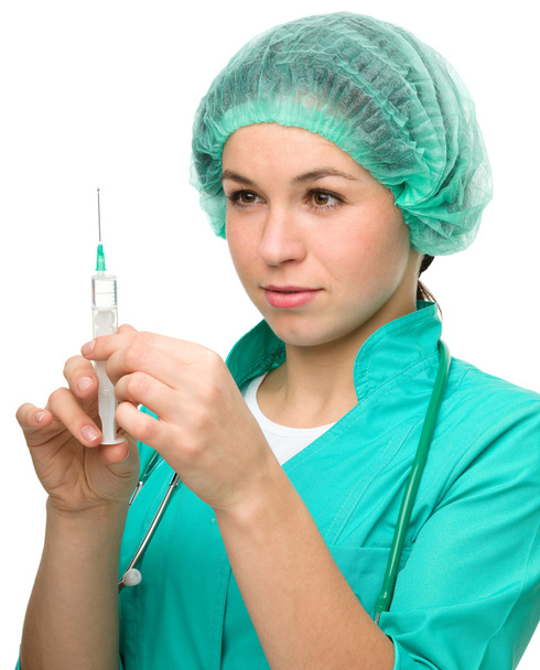 Young nurse is preparing syringe for injection - Foto, afbeelding