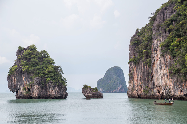 Phuket, Thailand - circa September 2015: Boat sails near limestone cliffs of Andaman Sea, Phang Nga Bay,  Thailand - Zdjęcie, obraz