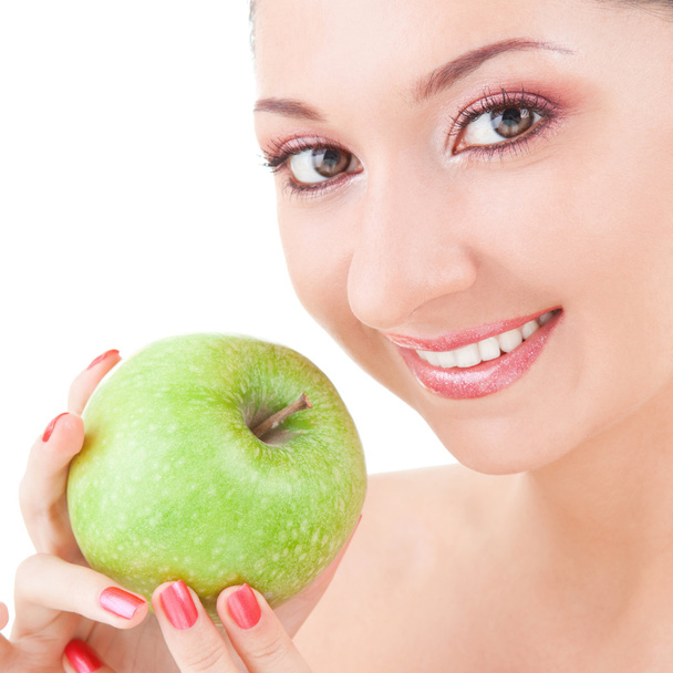 Sweet girl eating green apple on white background - Photo, image