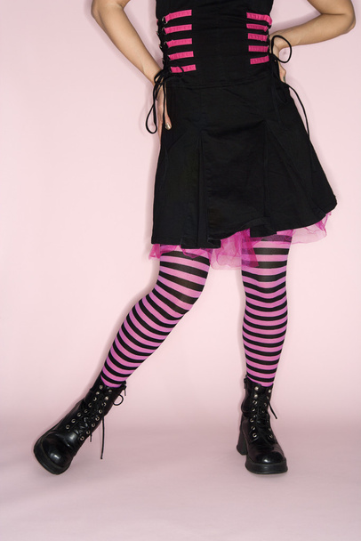 Woman wearing striped leggings. - Фото, зображення