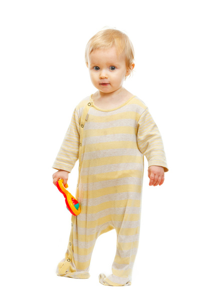 Cute kid standing with rattle on white background - Photo, Image