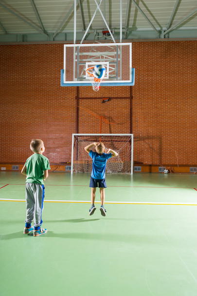 Two young boys practicing their basketball - Valokuva, kuva