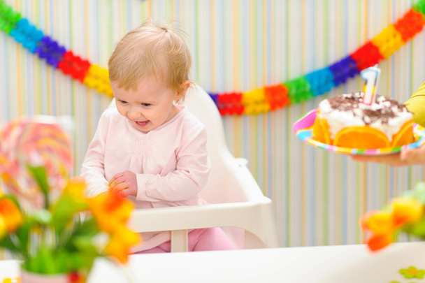 Baby happy and embarrassed receiving birthday cake - Zdjęcie, obraz
