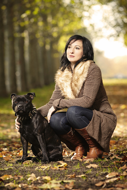 Woman and her Staffordshire bull terrier - Foto, afbeelding