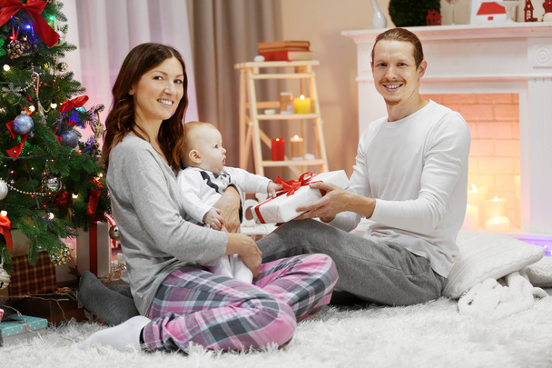 Parents with baby near Christmas tree  - Photo, image