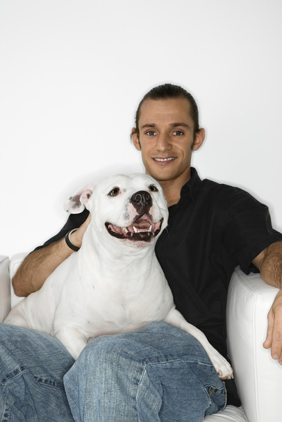 Man holding white dog. - Фото, зображення