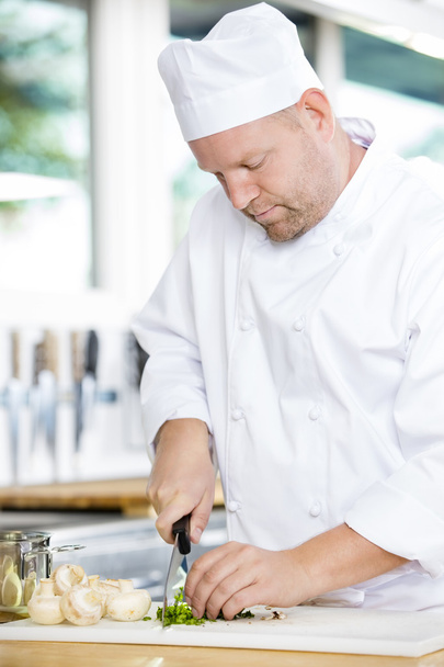 Professional chef preparing vegetables to a healthy dish - Photo, Image