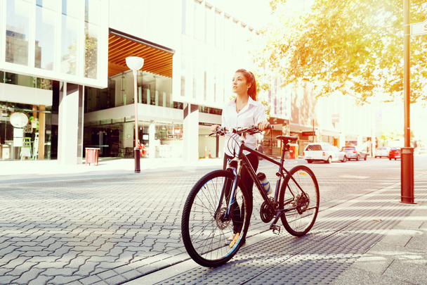 Portrait of happy young female bicyclist - 写真・画像