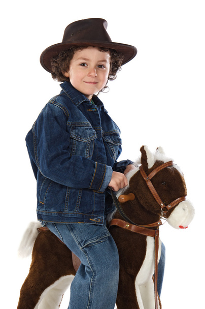 παιδί που είναι τοποθετημένο σε ένα ξύλινο άλογο - Φωτογραφία, εικόνα
