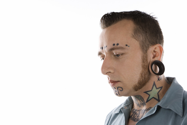 Man with tattoos and piercings. - Fotó, kép