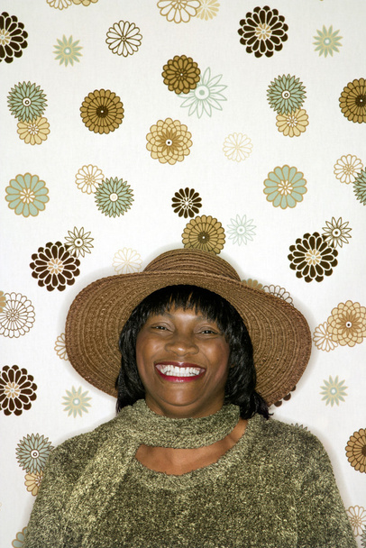 Smiling woman on flower background. - Photo, image