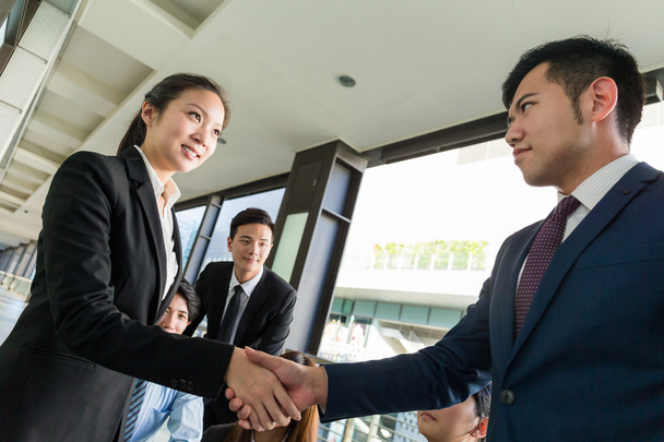 Businesswoman and businessman shaking hands - Photo, Image
