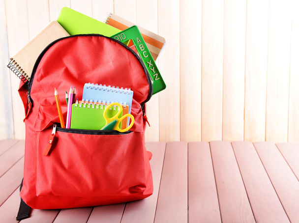 Red backpack full of stationery - Foto, Imagen