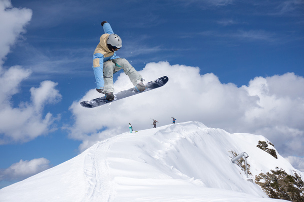 Flying snowboarder on mountains. Extreme sport. - Photo, Image