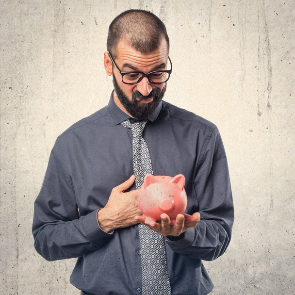 Man holding a piggybank - Foto, Bild